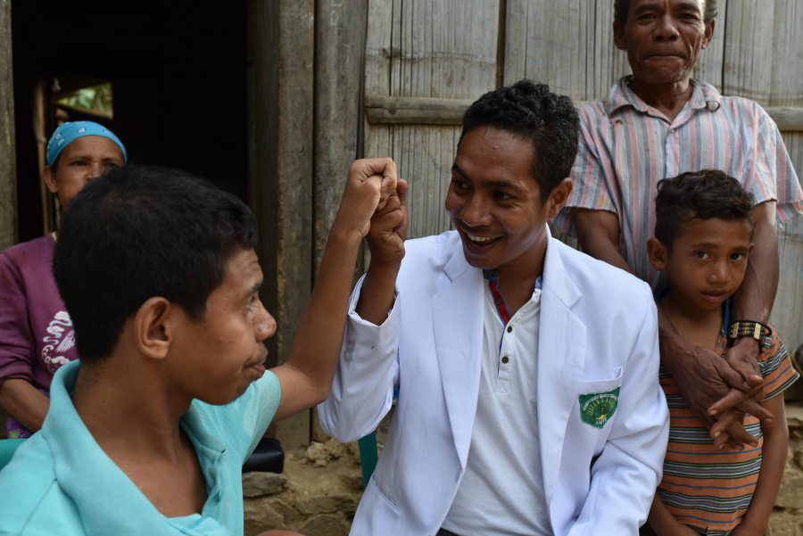 A Timorese nurse with a Timorese young boy